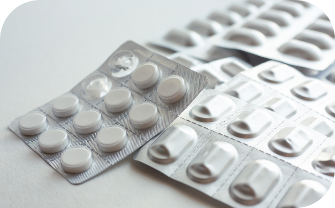 Partially open package of nicotine lozenges, with several more unopened packages in the background